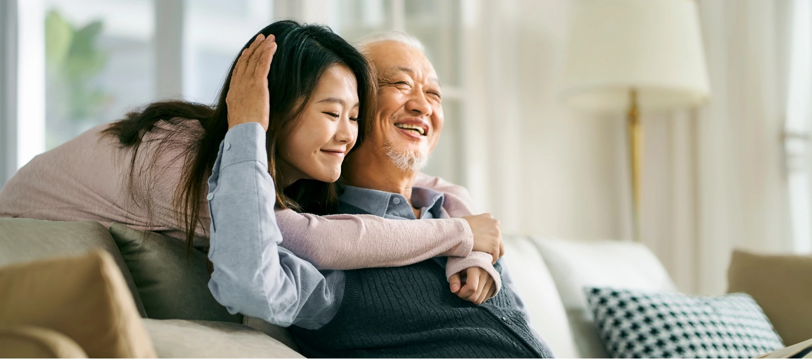 young asian woman giving grandfather loving hug