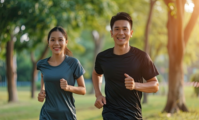 young couple running together in the park